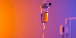 professional medical IV drip therapy treatment in a modern clinic setting, bright and clean environment, close-up of colorful vitamin infusion